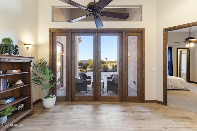 doorway to outside with ceiling fan, light hardwood / wood-style floors, and french doors