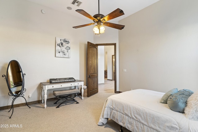 bedroom with ceiling fan, vaulted ceiling, and light carpet