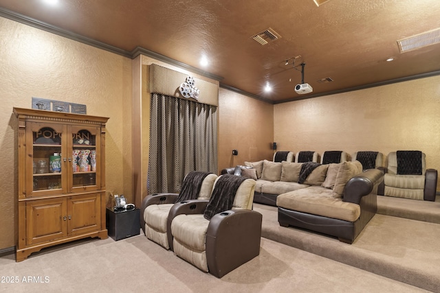 carpeted home theater room featuring ornamental molding