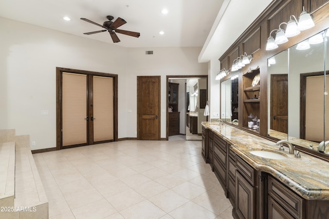 bathroom with tile patterned flooring, vanity, and ceiling fan