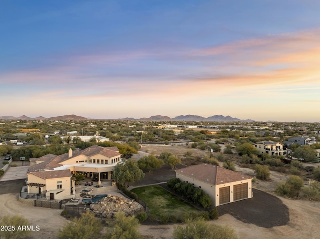 aerial view at dusk featuring a mountain view