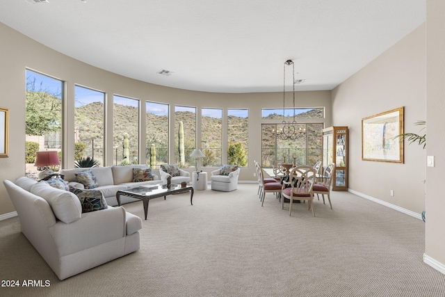 sunroom / solarium with a chandelier, a mountain view, and plenty of natural light