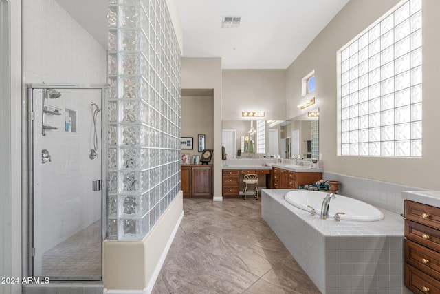 bathroom featuring independent shower and bath and vanity