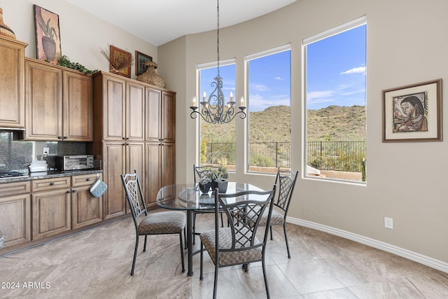 dining area featuring a healthy amount of sunlight and an inviting chandelier