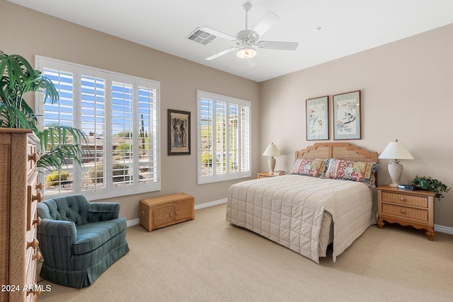 bedroom featuring light colored carpet and ceiling fan