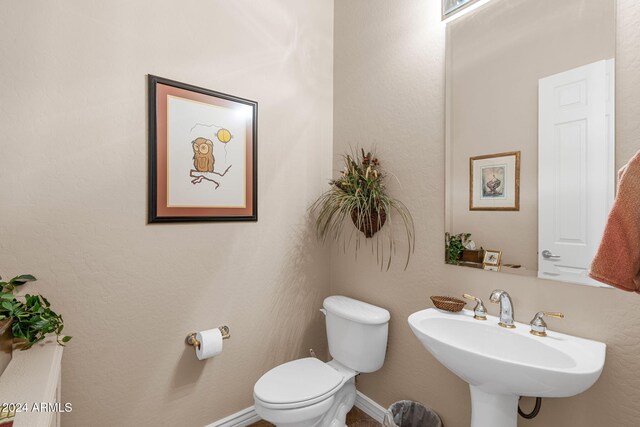 bathroom featuring toilet and sink