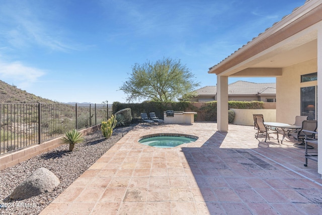 view of pool with a patio and an in ground hot tub