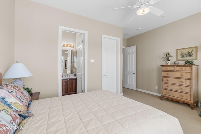 carpeted bedroom with ceiling fan, connected bathroom, and sink