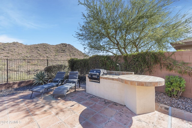 view of patio / terrace featuring grilling area, area for grilling, and a mountain view