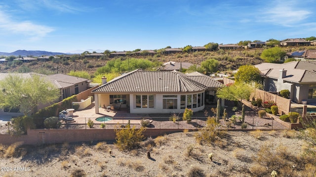 back of house featuring a patio area and a mountain view