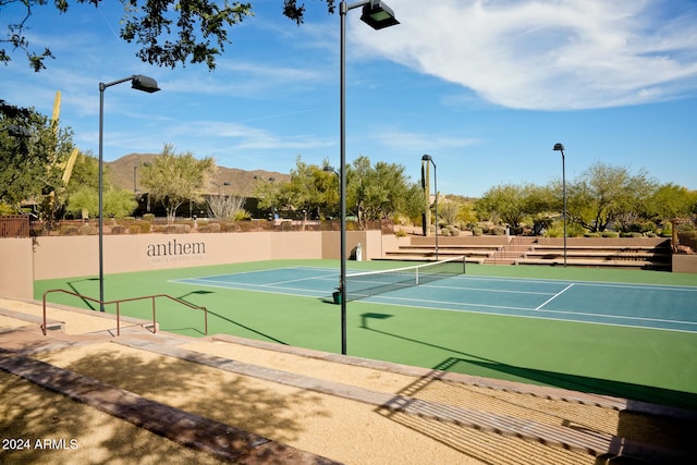 view of tennis court featuring a mountain view