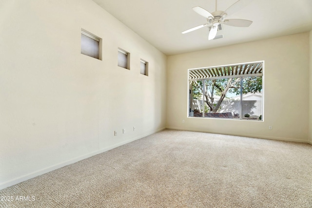 carpeted spare room featuring ceiling fan