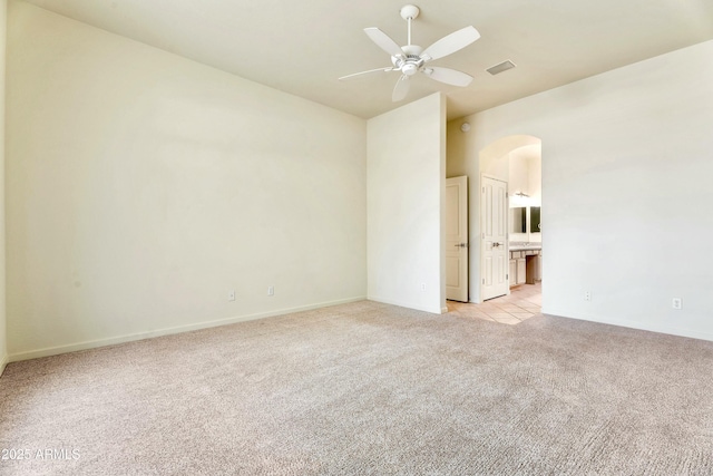 carpeted spare room featuring ceiling fan