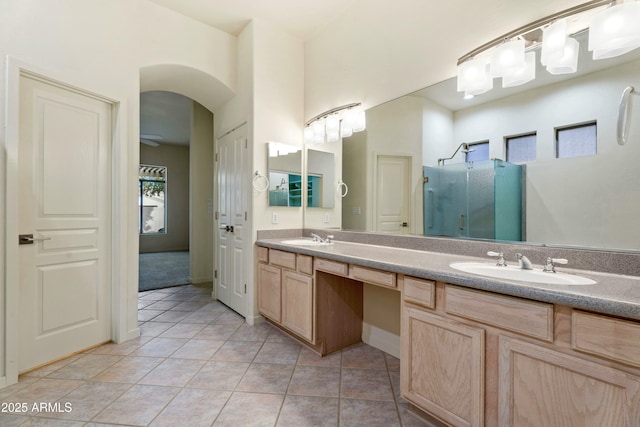 bathroom with tile patterned flooring, an enclosed shower, and vanity