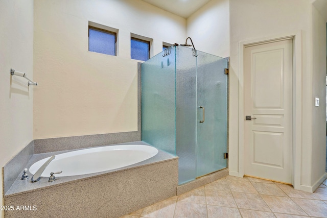 bathroom with tile patterned floors and shower with separate bathtub