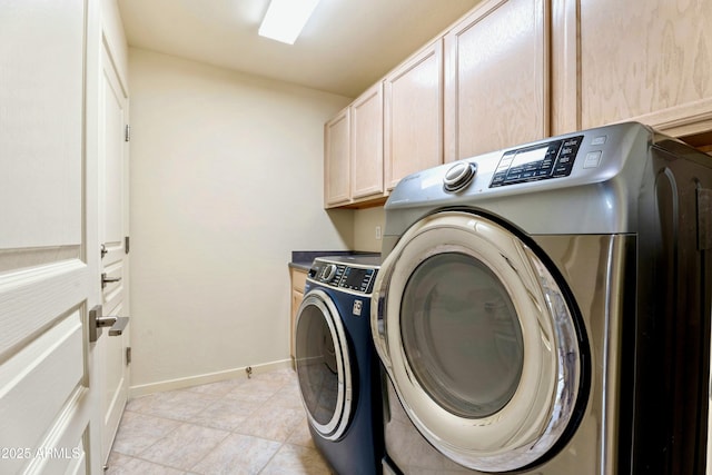 laundry area featuring washing machine and dryer and cabinets