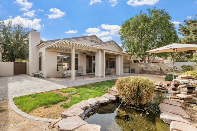 rear view of house with a patio and a pergola