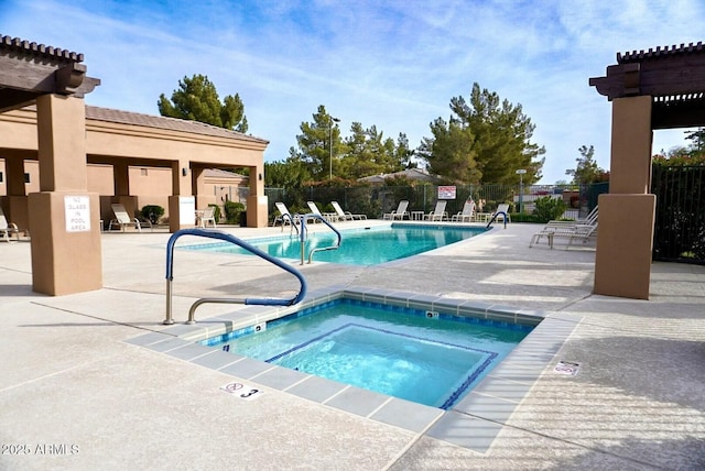 view of swimming pool featuring a patio and a community hot tub