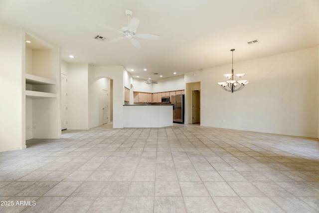 unfurnished living room featuring light tile patterned floors, built in shelves, and ceiling fan with notable chandelier