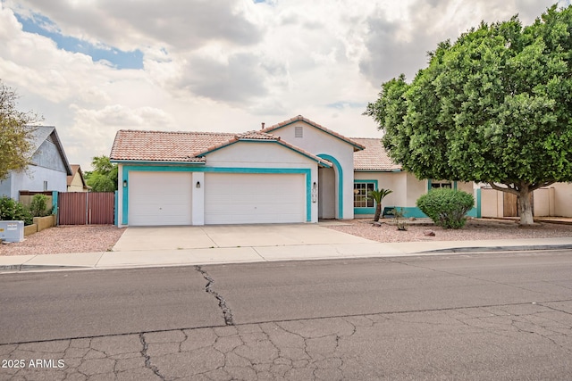 10215 W Missouri Ave, Glendale, AZ 85307 - mediterranean / spanish house with a tiled roof, a garage, stucco siding, and fence