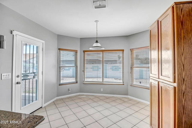 10215 W Missouri Ave, Glendale, AZ 85307 - unfurnished dining area with light tile patterned floors and baseboards