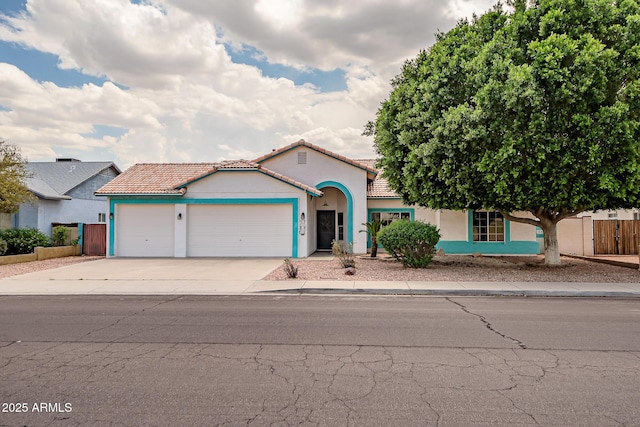 10215 W Missouri Ave, Glendale, AZ 85307 - mediterranean / spanish house with a garage, stucco siding, driveway, fence, and a tile roof