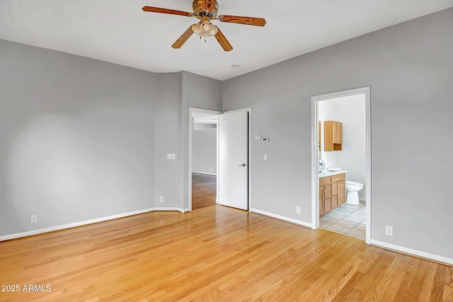 10215 W Missouri Ave, Glendale, AZ 85307 - unfurnished bedroom with light wood finished floors, ensuite bath, and baseboards