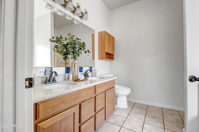 10215 W Missouri Ave, Glendale, AZ 85307 - full bathroom featuring tile patterned flooring, toilet, double vanity, and baseboards