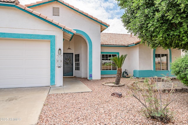 10215 W Missouri Ave, Glendale, AZ 85307 - view of front of house featuring a tiled roof, an attached garage, and stucco siding