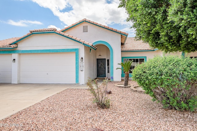 10215 W Missouri Ave, Glendale, AZ 85307 - mediterranean / spanish-style house with an attached garage, a tiled roof, driveway, and stucco siding