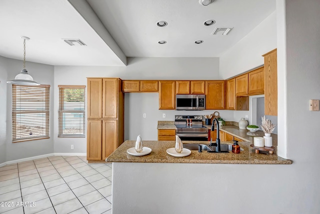 10215 W Missouri Ave, Glendale, AZ 85307 - kitchen with stainless steel appliances, a peninsula, a sink, light stone counters, and decorative light fixtures