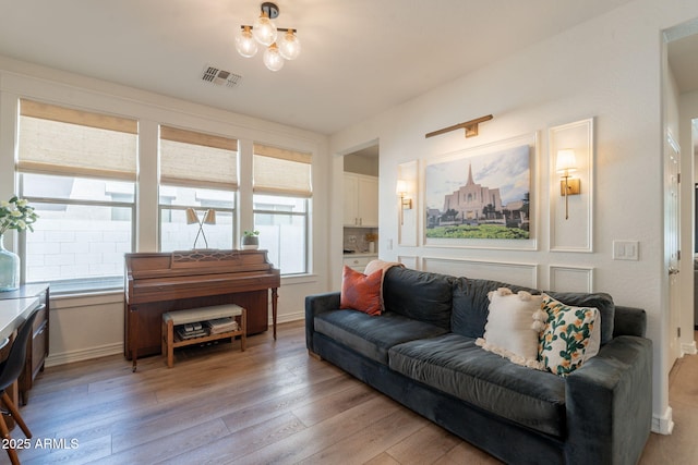 living room with light wood-type flooring and baseboards