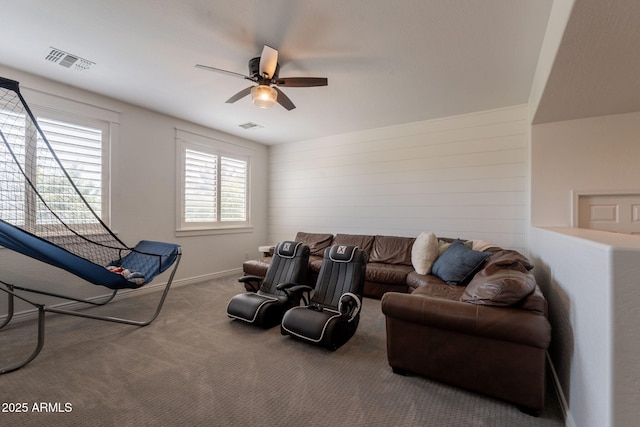 living area featuring a ceiling fan, carpet floors, and baseboards