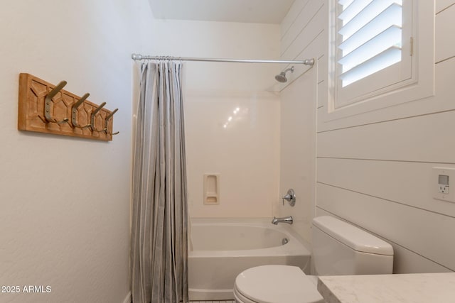 bathroom with toilet, shower / bathtub combination with curtain, and vanity