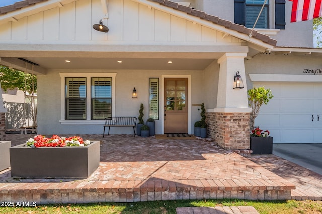 entrance to property with board and batten siding, a porch, and stucco siding