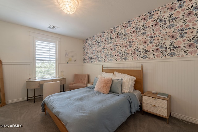 carpeted bedroom featuring wainscoting and baseboards