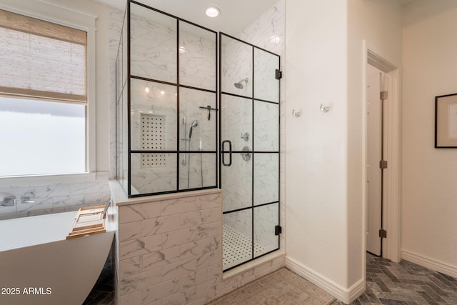 bathroom featuring a stall shower, baseboards, a freestanding bath, and recessed lighting