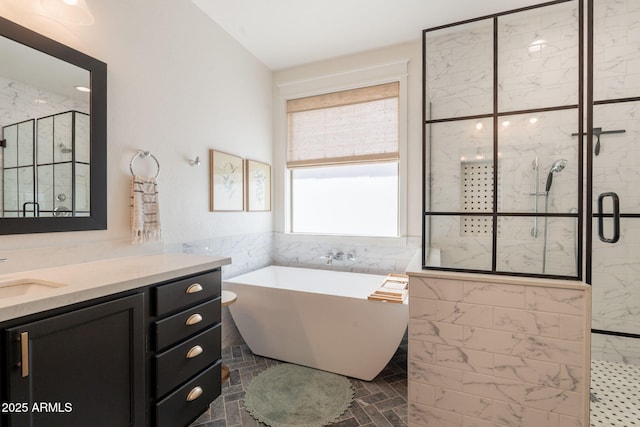 bathroom with a shower stall, a soaking tub, vanity, and tile walls