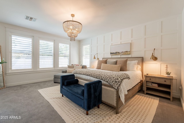 bedroom featuring a chandelier, light carpet, baseboards, and a decorative wall