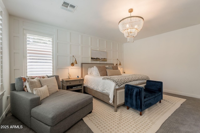 bedroom featuring a chandelier, baseboards, and carpet floors