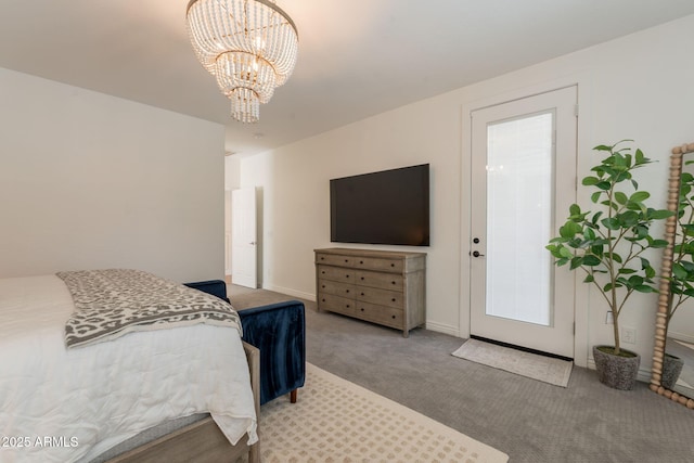 carpeted bedroom featuring a chandelier and baseboards