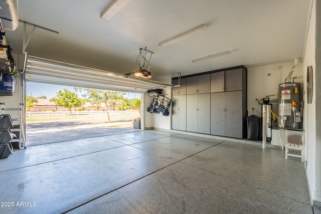 garage with water heater and a garage door opener