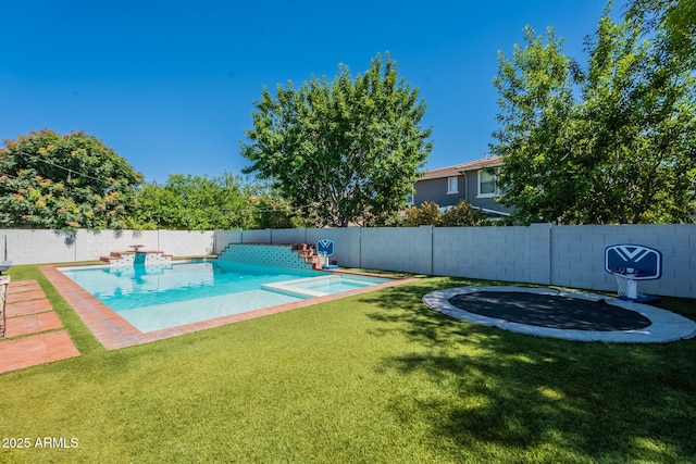 view of swimming pool featuring a trampoline and a pool with connected hot tub
