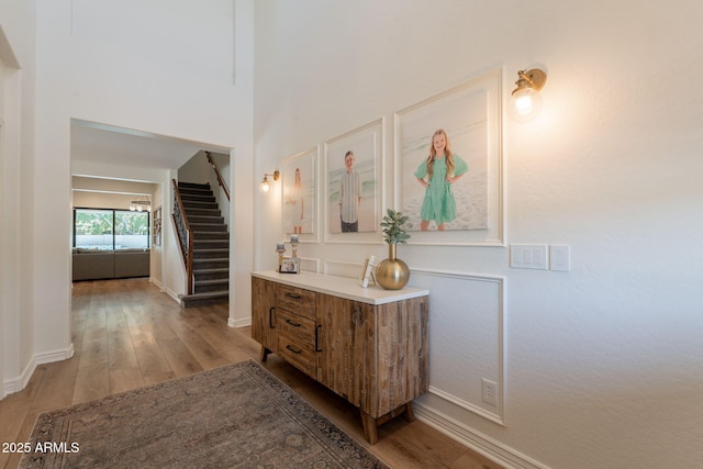 bathroom with wood finished floors, baseboards, and vanity