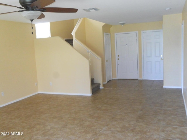 interior space with ceiling fan