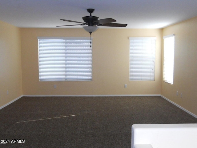 carpeted spare room with ceiling fan