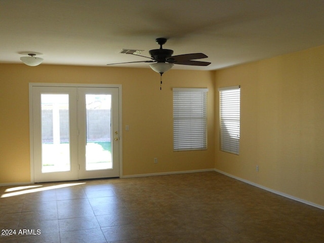 spare room with plenty of natural light and ceiling fan