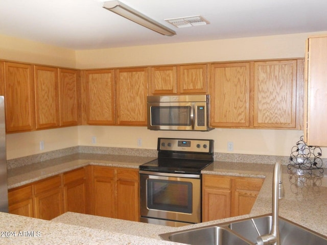 kitchen with sink and appliances with stainless steel finishes