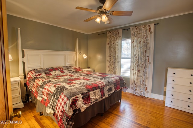 bedroom featuring ceiling fan, wood-type flooring, and ornamental molding