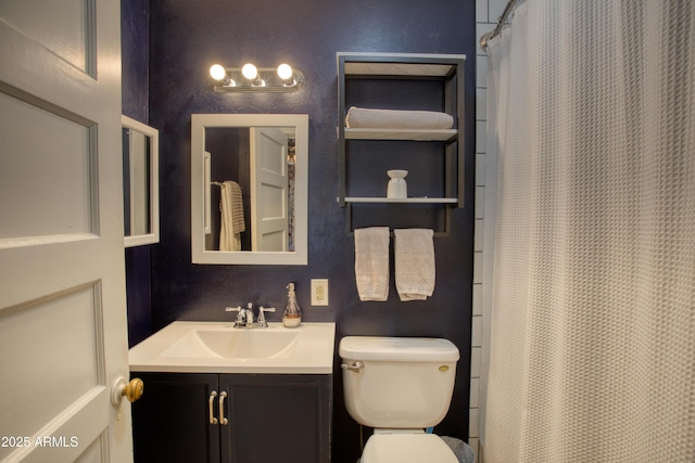 bathroom featuring curtained shower, toilet, and vanity